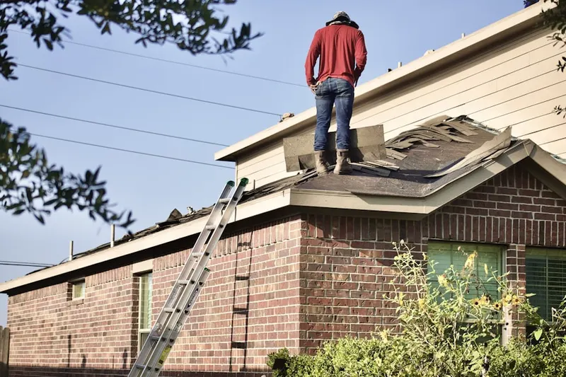 Professional roofer working on a residential roof in Garrison Forest